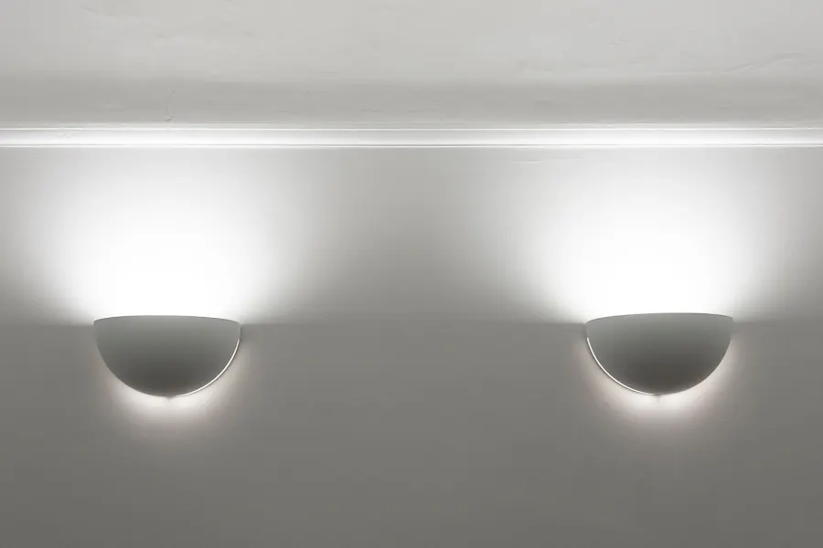 Two wall lights illuminating a finished room